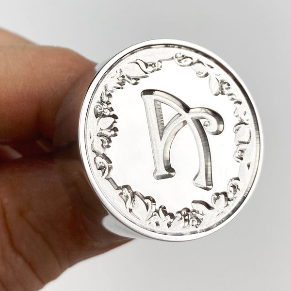 Harrington font wax seal stamp avaiable in your choice of initial.  Pictured is A with the ivy border.  Created by letterseals.com.