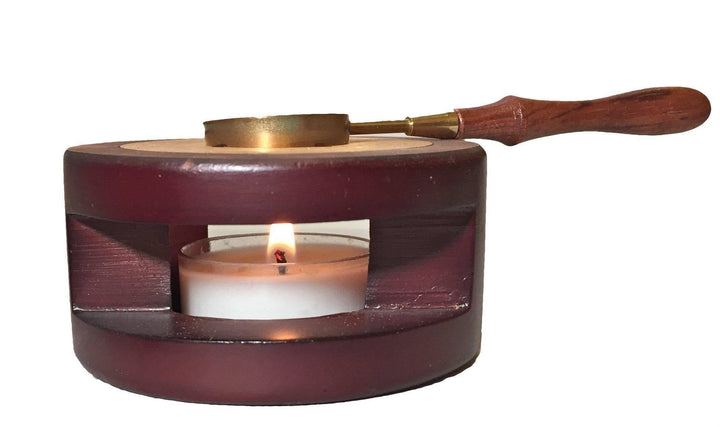Sealing wax melting platform.  The spoon with wax rests on a platform with a candle underneath heating and melting the wax.  Created by letterseals.com
