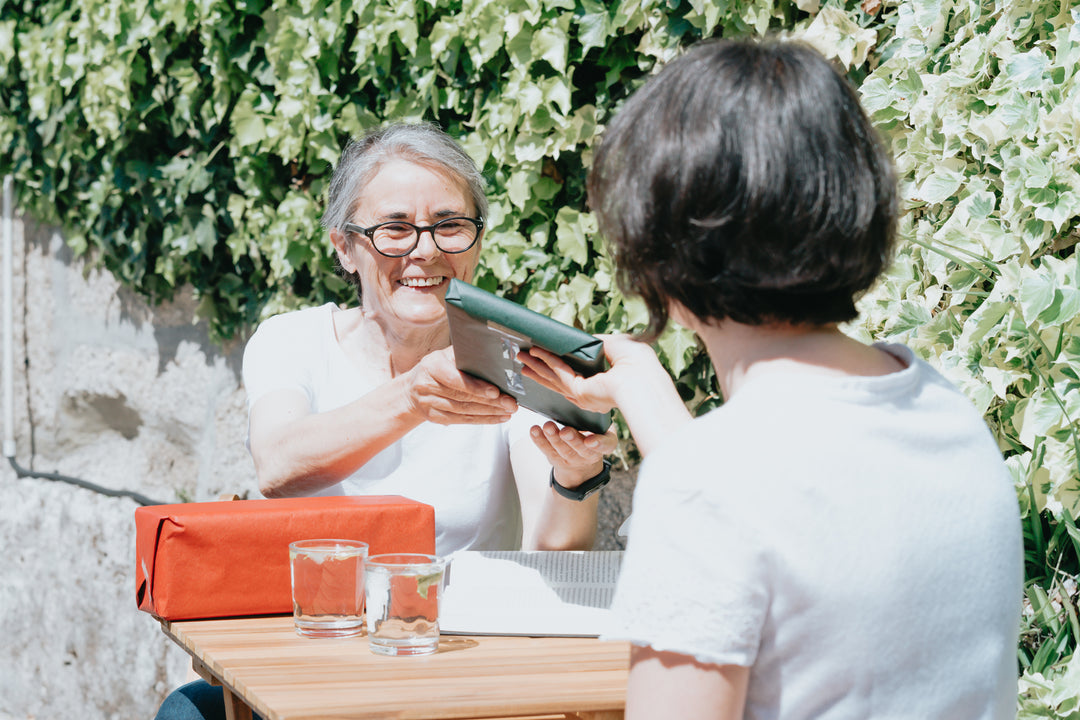 woman-accepts-a-wrapped-gift-from-a-friend[product-name]-LetterSeals.com